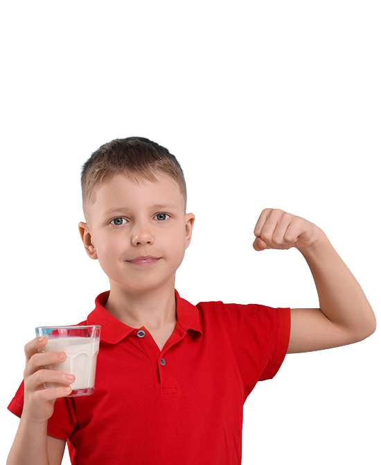 Niño sonriente en camisa roja sosteniendo vaso de leche mostrando músculo