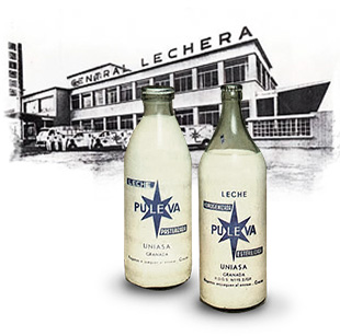 Botellas Puleva vintage con fábrica Lechera histórica - patrimonio de marca